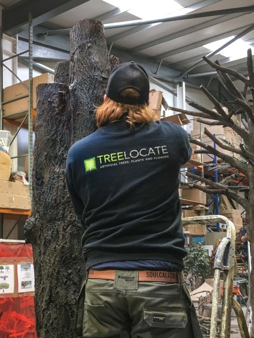 man constructing artificial trunk